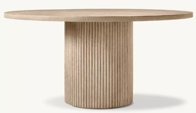 A contemporary round dining table featuring a light wood finish and a distinctive vertically fluted cylindrical pedestal base. — 3D model