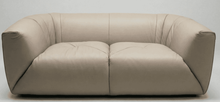 A modern two-seater sofa upholstered in light beige leather, featuring a plush, rounded design with… — 3D model