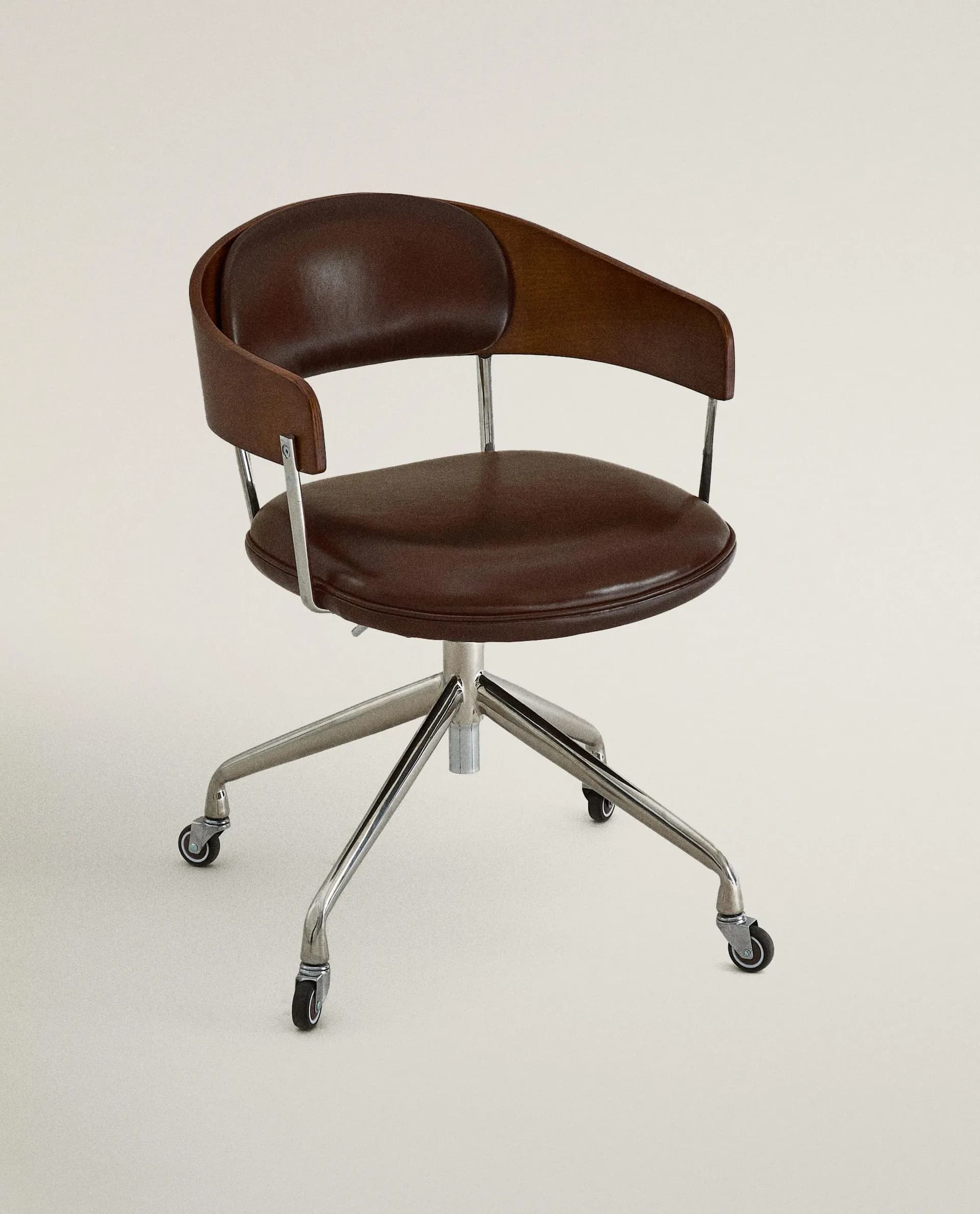 A brown leather upholstered swivel desk chair featuring a bentwood back shell and a five-star chrome caster base. — 3D model