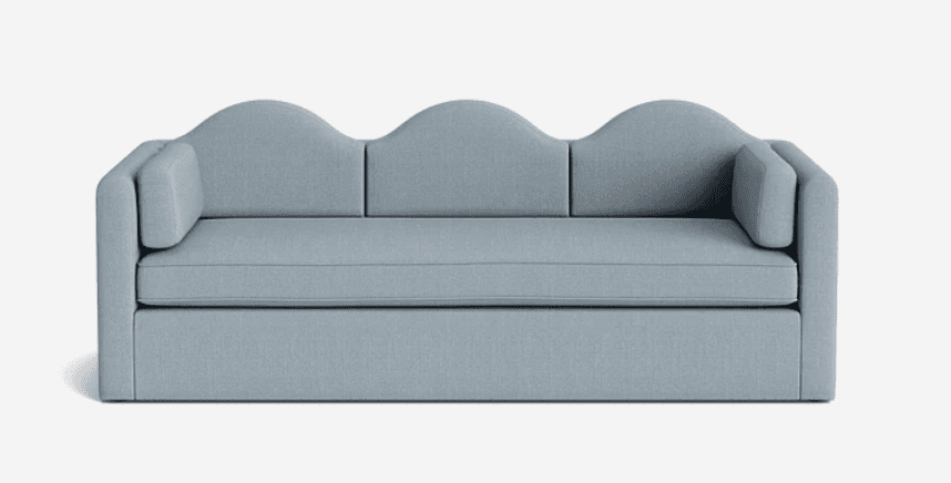 A light blue upholstered sofa with a distinctive three-arched, wavy backrest. It features three seat cushions and two cylindrical bolster cushions acting as armrests. The sofa has a low-profile base. — 3D model