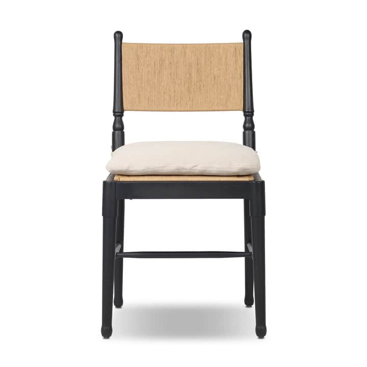 A contemporary dining chair featuring a solid black wooden frame, a natural woven rattan backrest, a… — 3D model