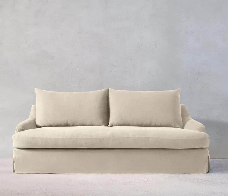 A upholstered sofa with a slipcover design. It features a plush seat and back cushions, with two rec… — free GLTF 3D model