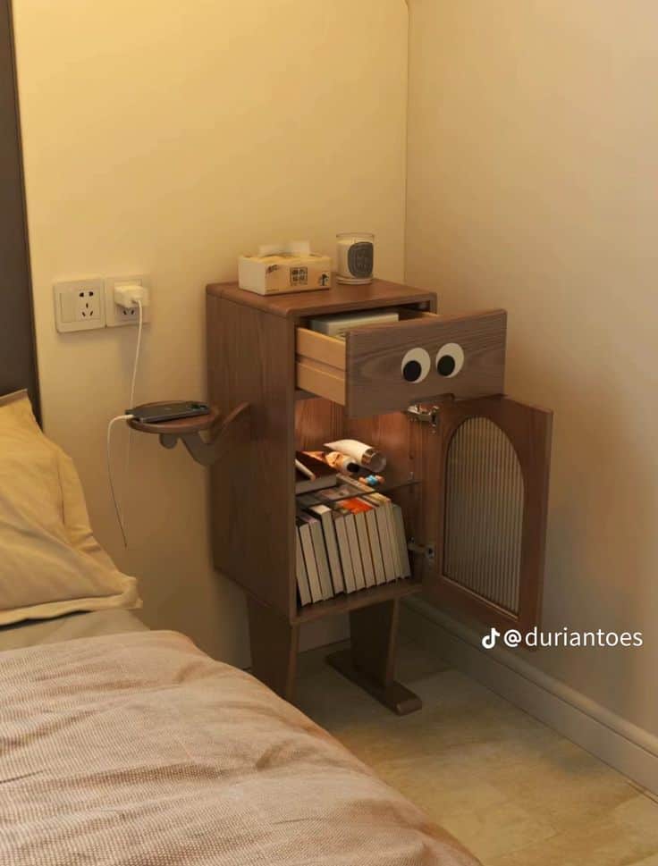 A whimsical wooden nightstand featuring a single drawer with decorative "googly eyes" and a lower ca… — 3D model