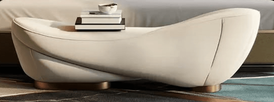 A modern, sculptural chaise lounge upholstered in a light, cream-colored material, featuring a smoothly curved form and a recessed gold-toned metallic base. — 3D model