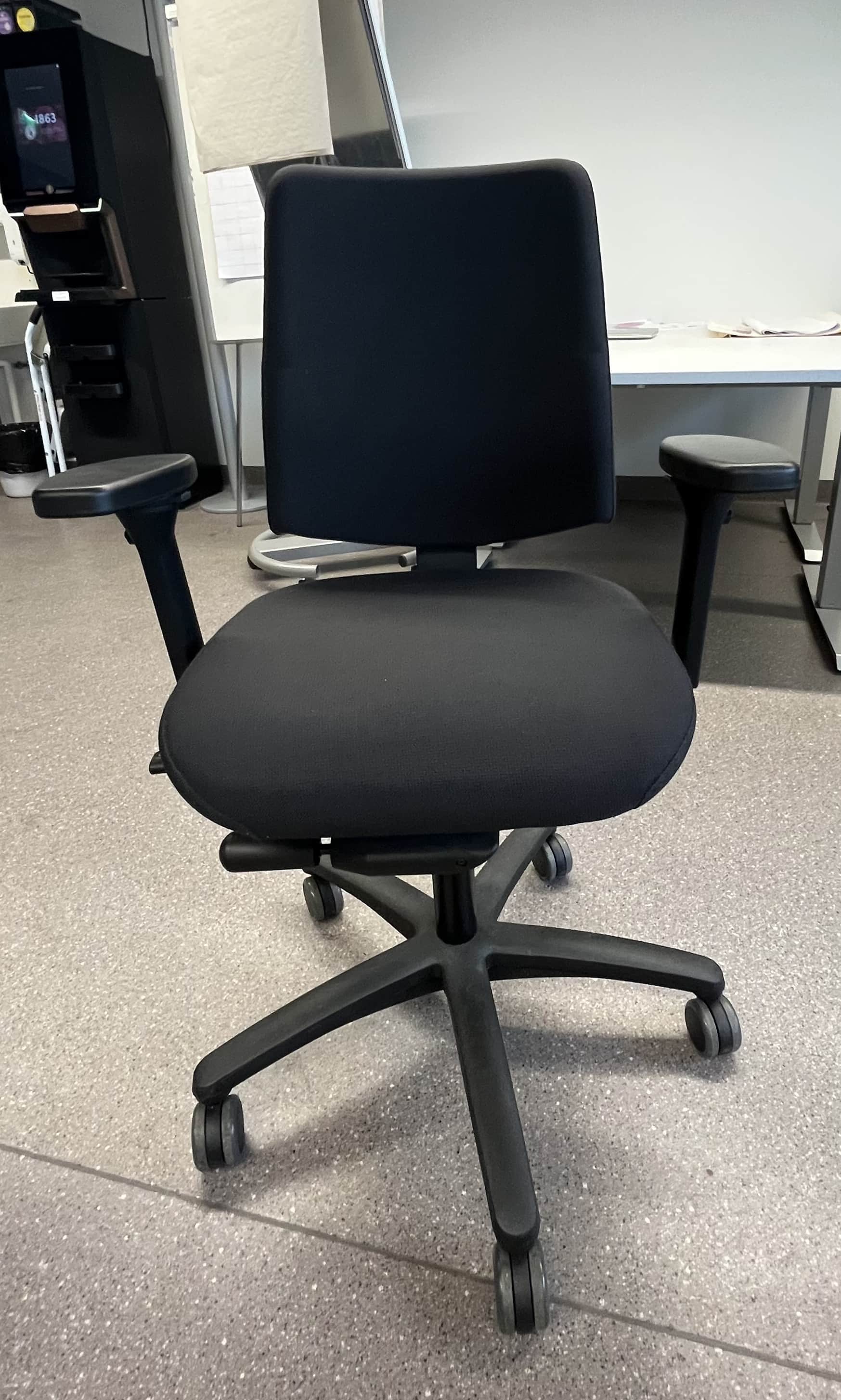 A modern office chair featuring black fabric upholstery on both the seat and backrest. It has a five… — 3D model
