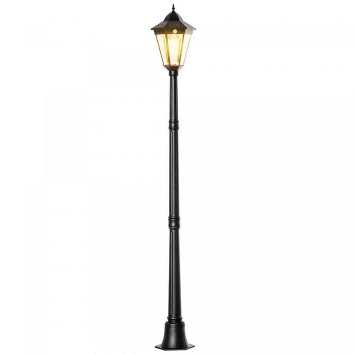 A tall, black outdoor post lamp featuring a multi-faceted lantern-style head mounted atop a decorative, fluted pole and a flared base. The light emitted is a warm, yellowish glow. — 3D model