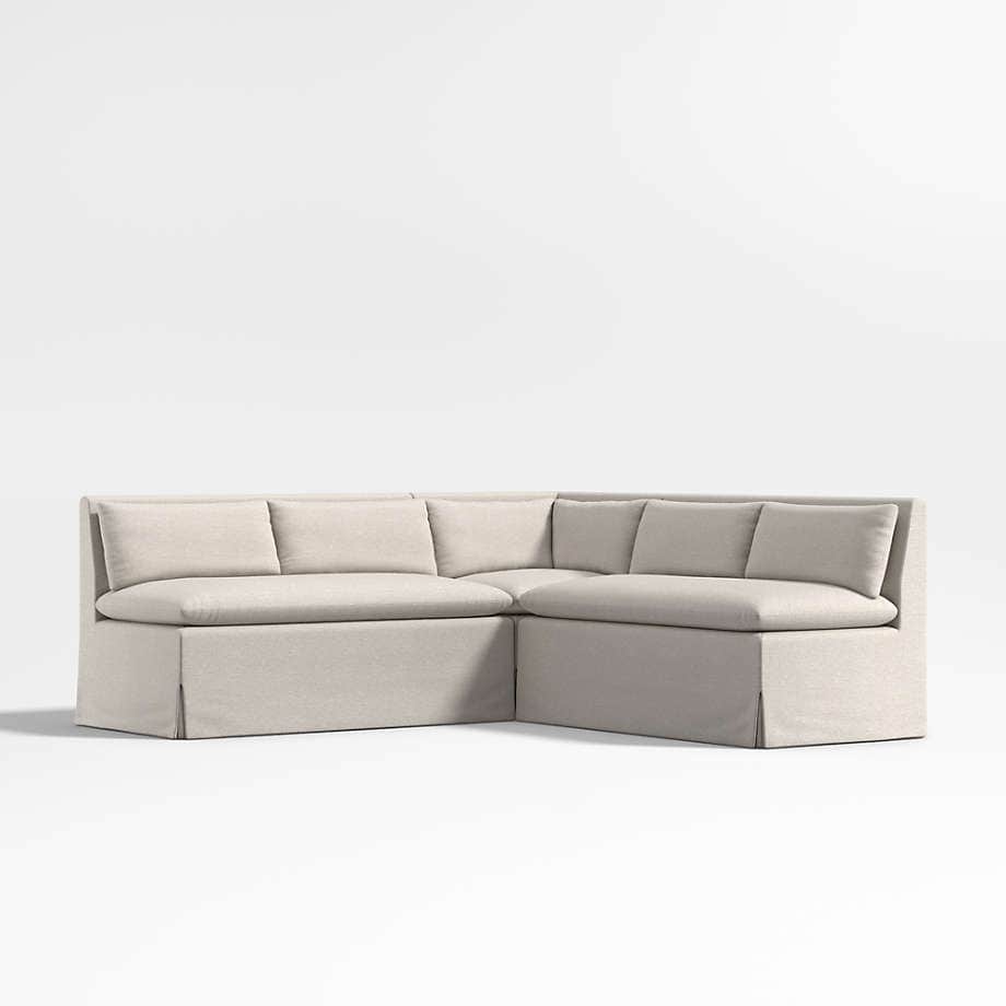 A sectional sofa with a skirted base and loose back cushions. The sofa is upholstered in a light-col… — free SKP 3D model