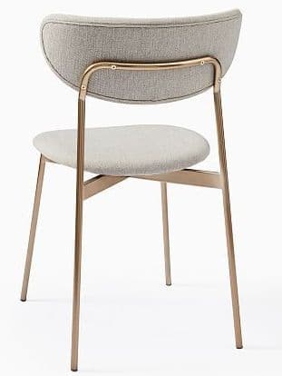 A contemporary dining chair featuring a gracefully curved, upholstered backrest and a coordinating rounded, padded seat. The chair is supported by four slender, slightly angled metal legs with a metallic bronze finish, connected by a cross-brace beneath the seat and an integrated curved bar supporting the backrest. — 3D model