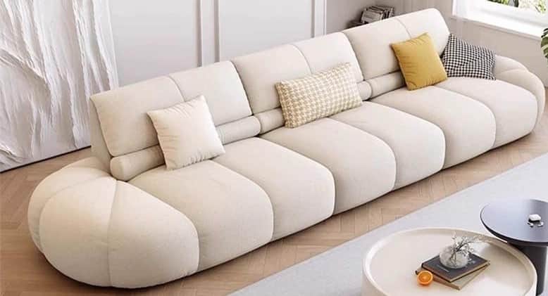 A long, low-profile sofa with a rounded, segmented base and backrest. The sofa features tufted or ch… — free OBJ 3D model