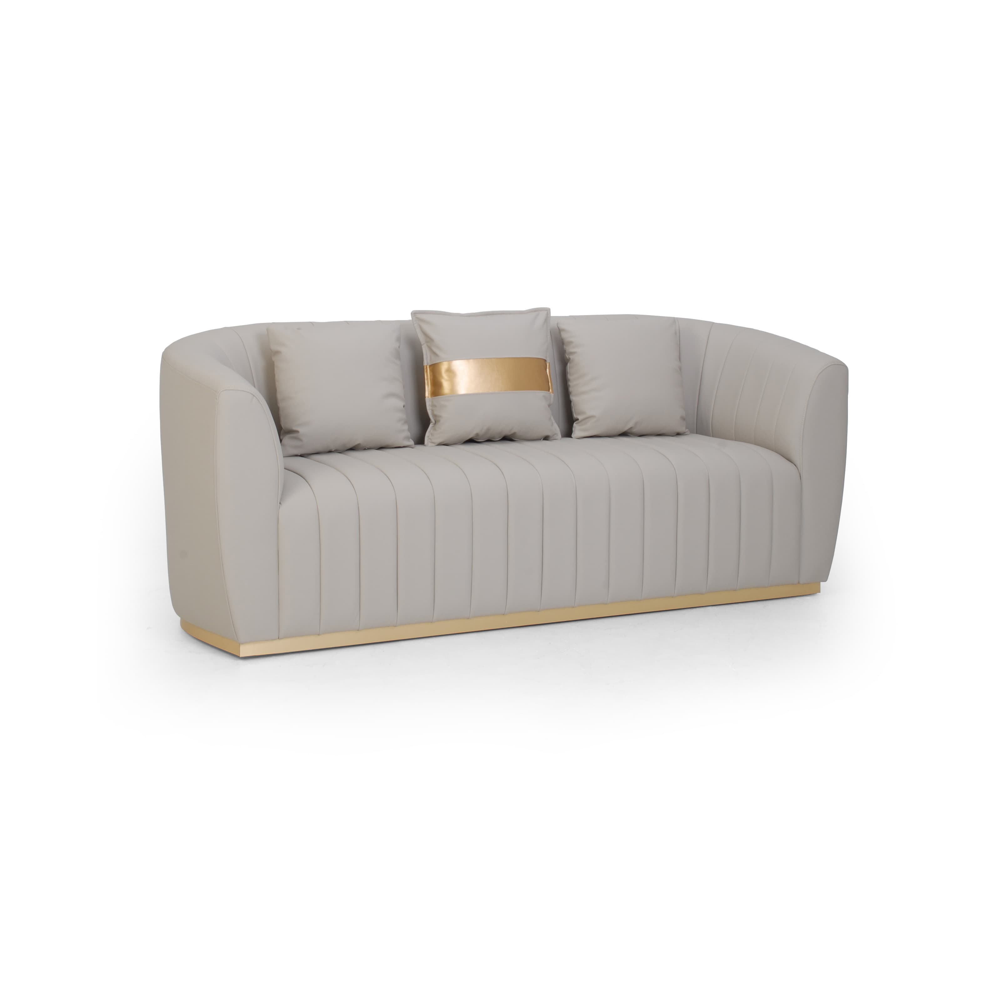 A contemporary light beige or gray upholstered loveseat featuring a curved silhouette, vertical channel tufting on the back and front apron, and a continuous polished gold-toned plinth base. It is accompanied by three loose back cushions, one of which includes a horizontal gold accent band. — 3D model
