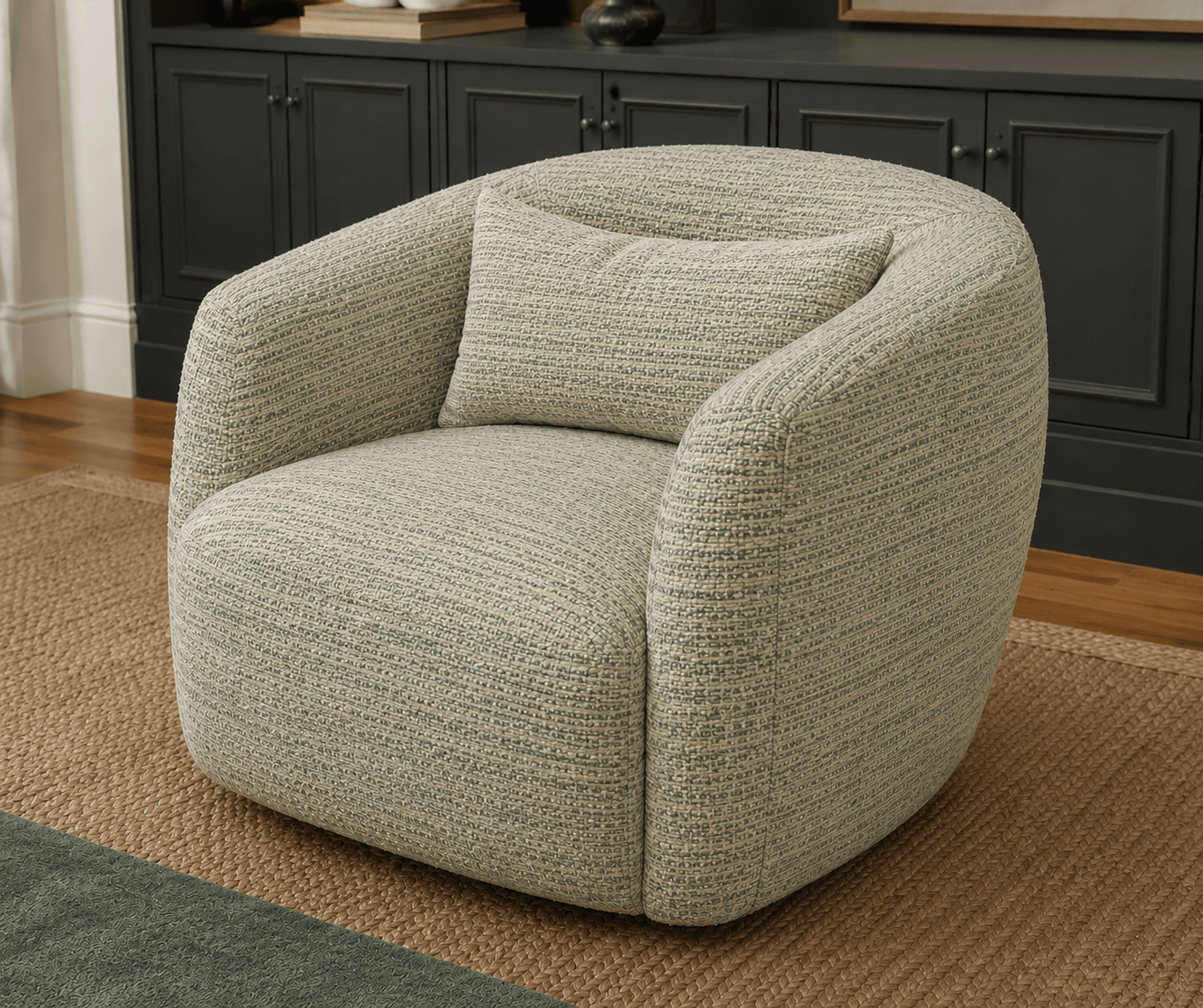 A contemporary upholstered swivel accent chair with a rounded, barrel-like silhouette, featuring a textured green and beige fabric and a matching throw pillow. — 3D model