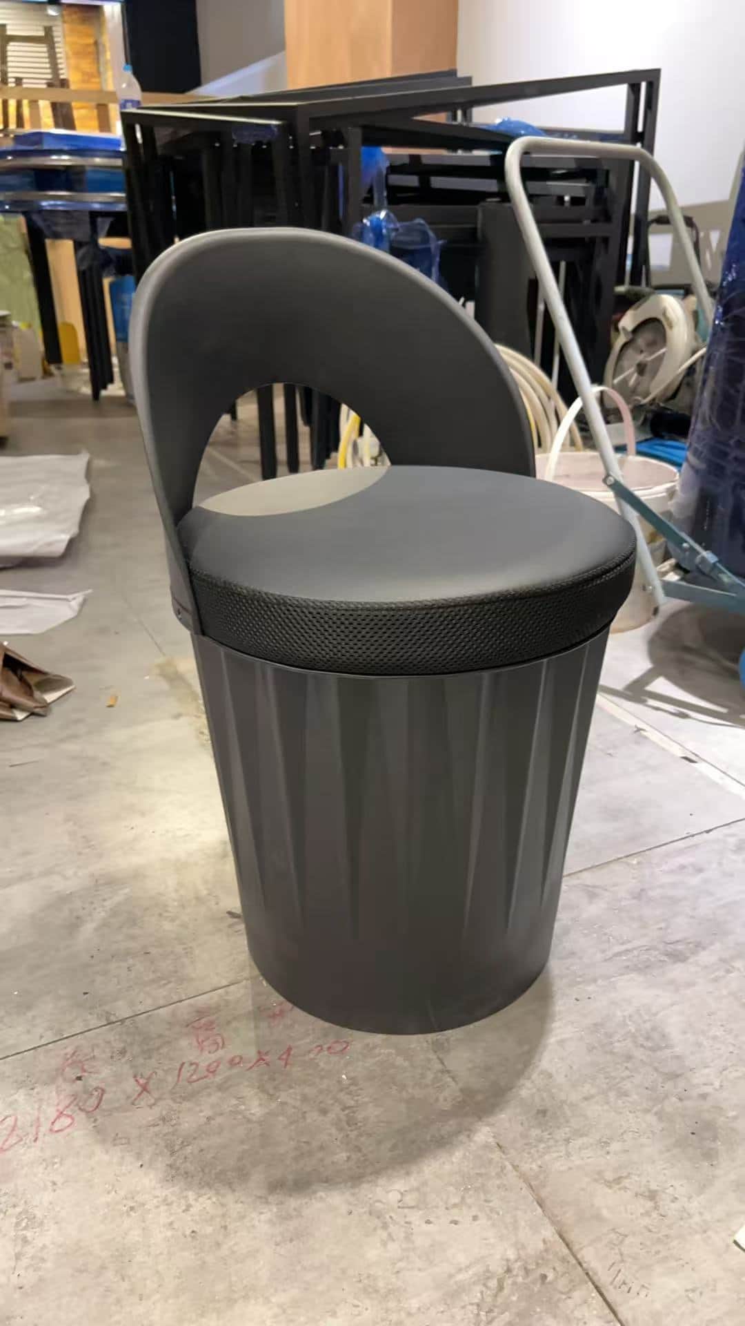A modern, monochromatic dark gray stool featuring a cylindrical base with vertical fluting and a rou… — 3D model