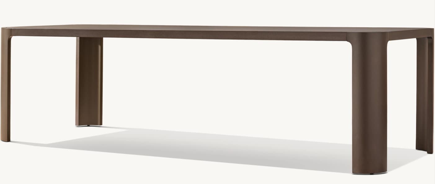 A modern dining table with a rectangular top and four cylindrical legs that are integrated into the structure. The legs have a subtle curve where they meet the tabletop. — 3D model