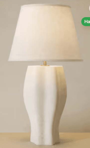 A modern table lamp featuring a sculptural, fluted ceramic base in a matte white finish, topped with… — 3D model