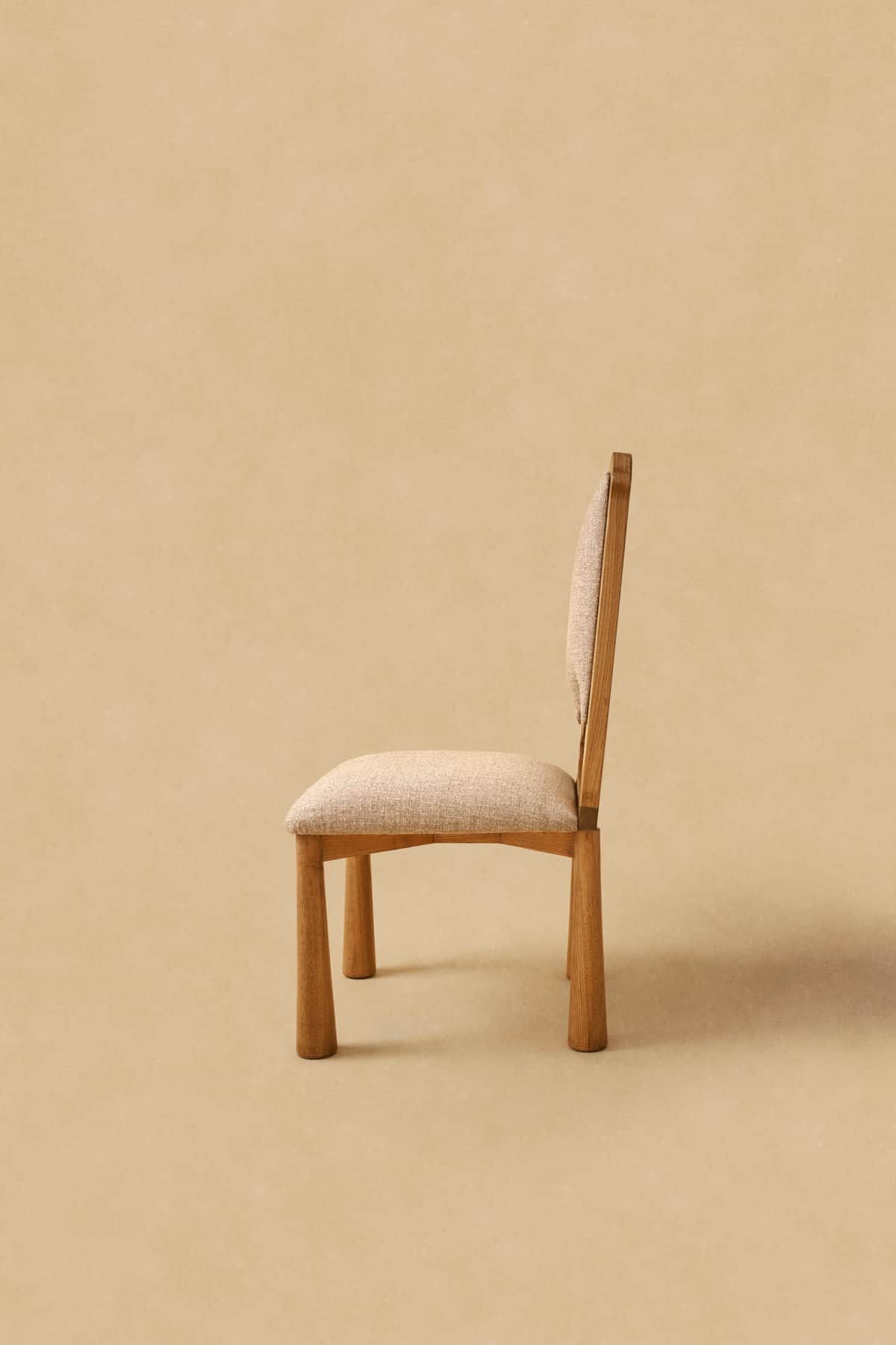 A modern armless chair featuring a wooden frame and upholstered seat and backrest. The chair's legs… — free FBX 3D model