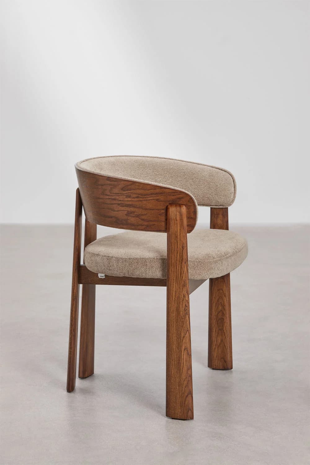 A modern armchair featuring a curved wooden back frame and integrated armrests, complemented by upholstered seat and back cushions. The chair stands on four sturdy, tapered wooden legs. — 3D model