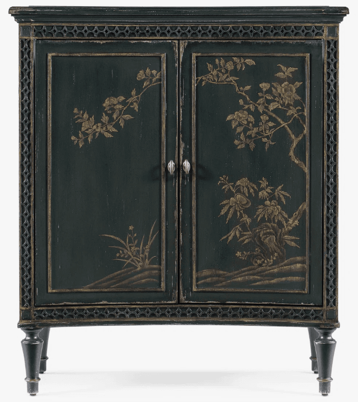 A dark green cabinet with two doors, featuring ornate gold-colored chinoiserie-style painted motifs of branches, flowers, and foliage. The cabinet has decorative trim around the top and bottom edges, and intricate patterned borders on the sides. It stands on four turned legs. The doors are fitted with two silver-toned drawer pulls. The finish appears distressed, suggesting an antique or vintage aesthetic. — 3D model