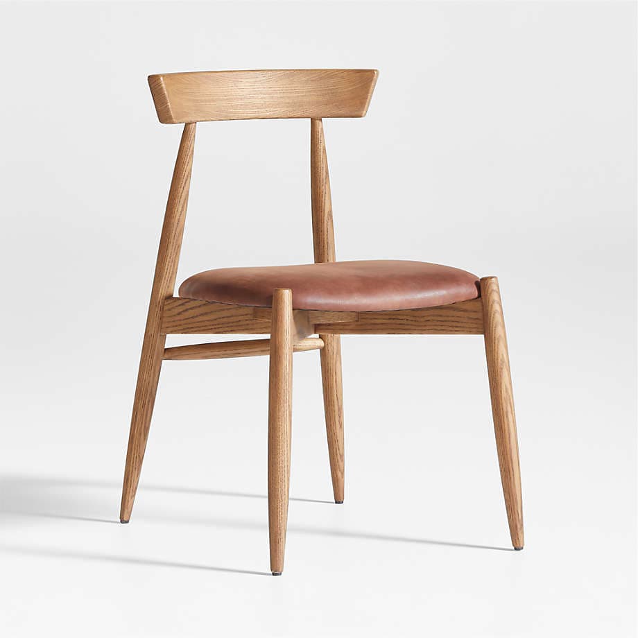 A modern dining chair constructed from light-toned oak wood with a brown leather upholstered seat. The chair features a minimalist design with tapered legs, a subtly curved backrest, and a sturdy wooden frame. — 3D model