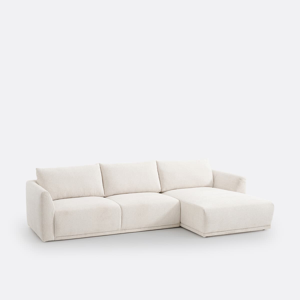 An off-white, contemporary sectional sofa featuring a main seating section and a right-hand facing chaise lounge, upholstered in a textured fabric. — 3D model