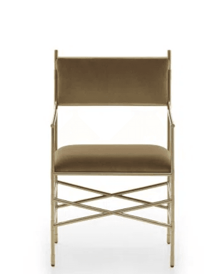 A modern glam armchair featuring a sleek gold-finished metal frame and plush velvet upholstery in a taupe or light brown color. The frame includes distinctive X-shaped cross-bracing on the sides and back, providing both structural support and a decorative element. It has integrated slender armrests and a cushioned seat and back. — 3D model