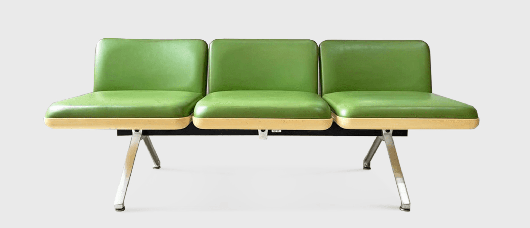 A three-seater bench with bright green, upholstered seats and backrests. The base of each seat appears to be made of a light-colored, possibly wood or laminate material, with a contrasting black support structure underneath. The bench is supported by two angled, chrome-finished metal legs. — 3D model