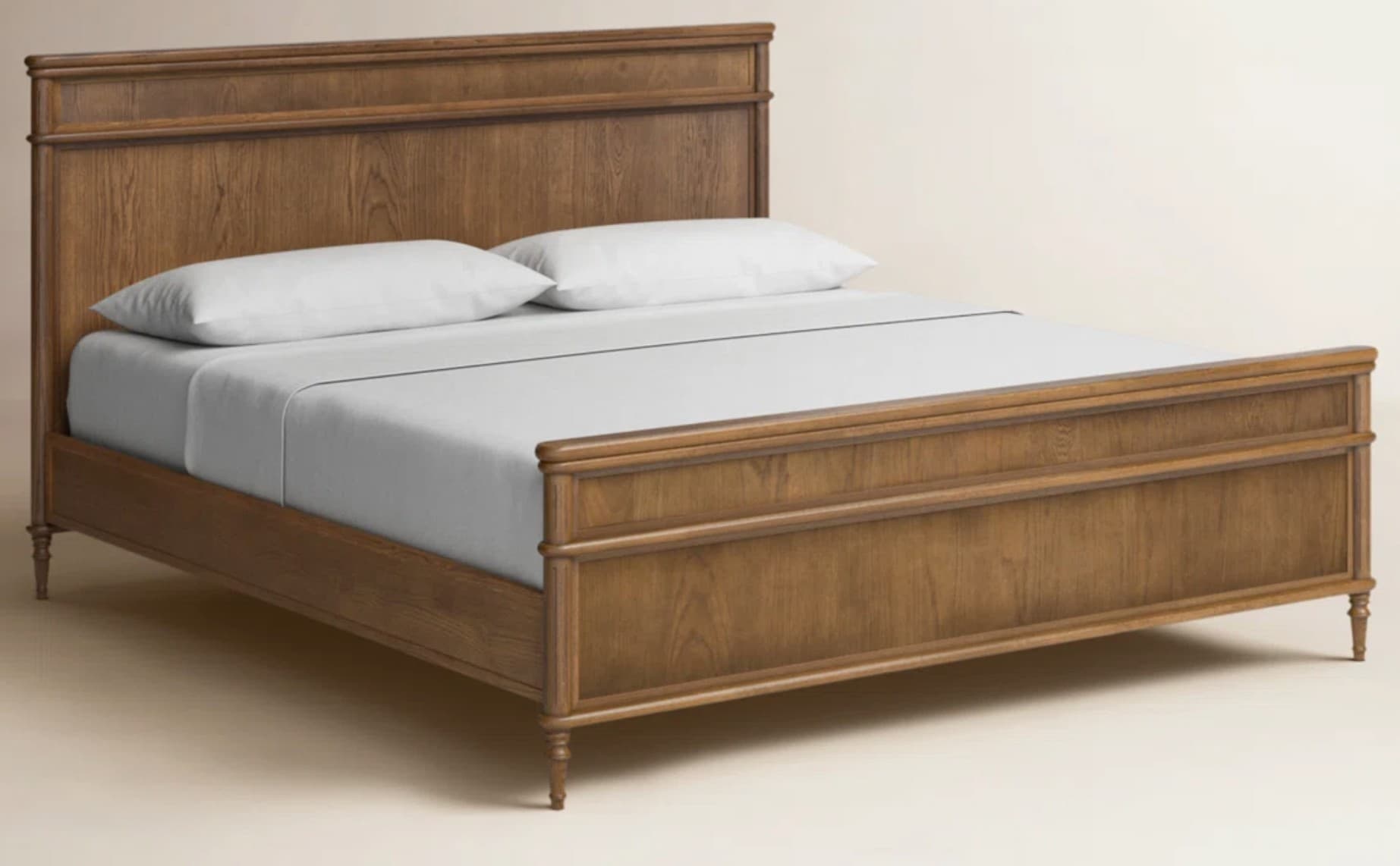 A wooden bed frame with a headboard and footboard, featuring a paneled design and turned legs. The bed is made of wood with a visible grain, finished in a warm brown tone. It is dressed with white bedding and two pillows. — 3D model