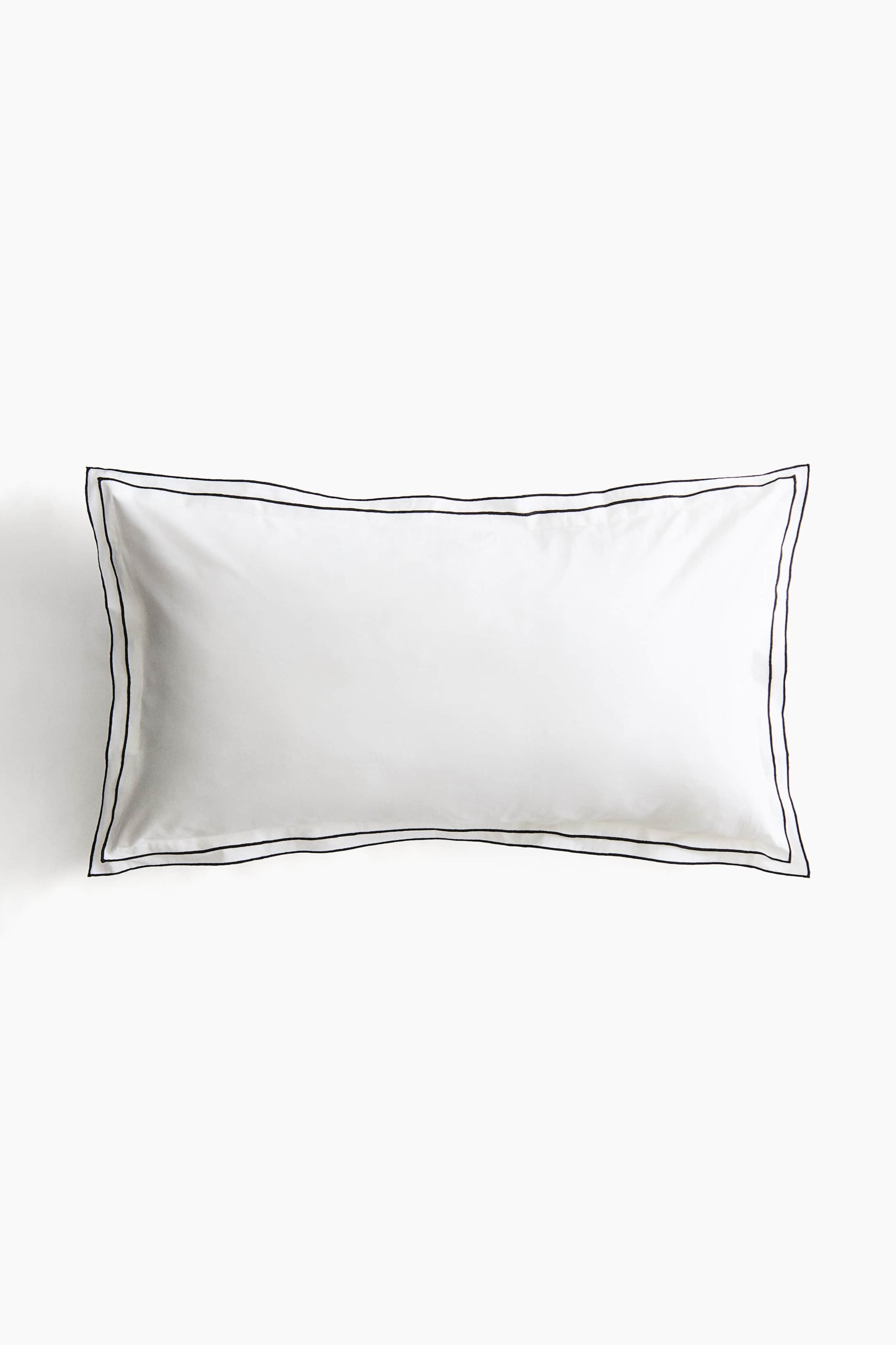 A white pillow with a rectangular shape, featuring a clean design with a double line of dark stitchi… — 3D model