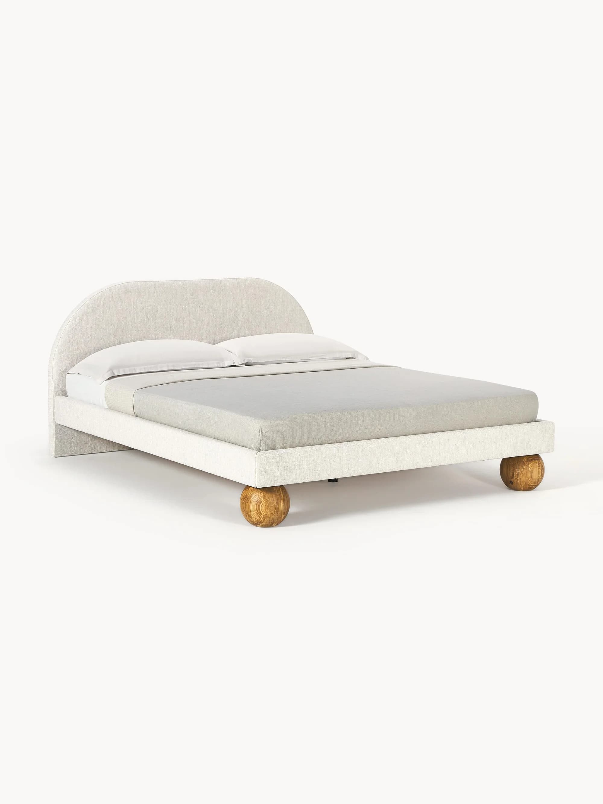 An upholstered bed frame featuring a gently arched headboard and distinctive spherical wooden feet, presented with neutral bedding. — 3D model