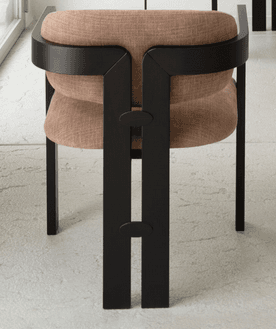 A chair with a distinctive, modern design featuring a robust black frame and a cushioned seat and back. The frame has an angular, geometric structure with visible joinery details. The upholstery appears to be a textured fabric. — 3D model
