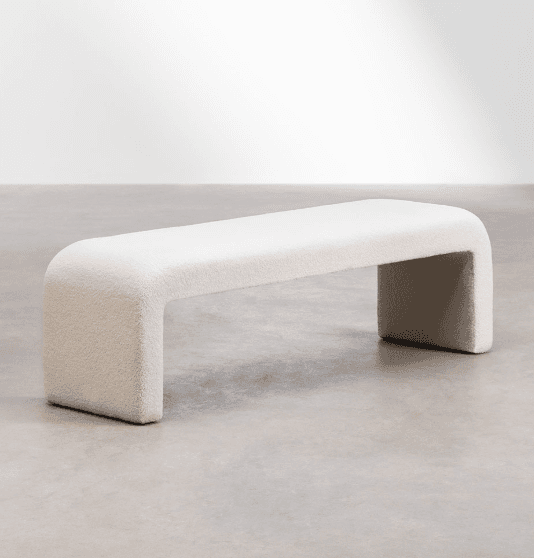 A cream-colored, bouclé upholstered bench with a rounded, continuous form. The bench has a singular, sculptural design where the seat and legs are integrated into a unified U-shape, creating a modern and minimalist aesthetic. — 3D model