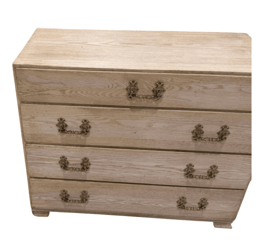 A four-drawer chest of drawers made from bleached oak wood, featuring ornate brass pull handles and a light, natural wood finish. — 3D model