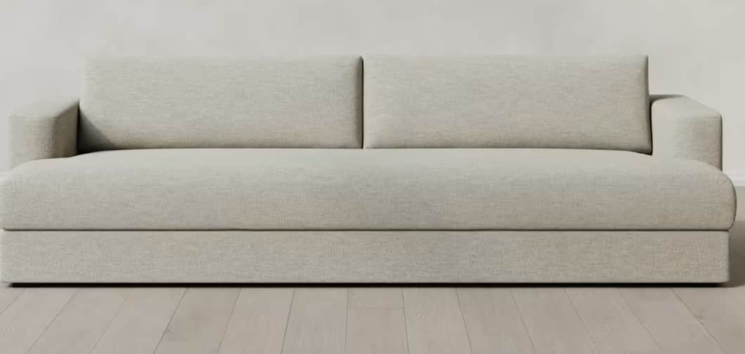 A modern, light grey upholstered seating unit featuring a single armrest and a backrest composed of… — 3D model