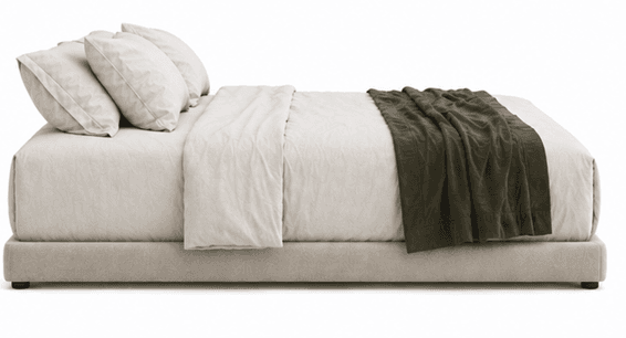 A low-profile upholstered bed frame with a headboard composed of three pillows and bedding. A folded blanket is draped across the foot of the bed. — 3D model