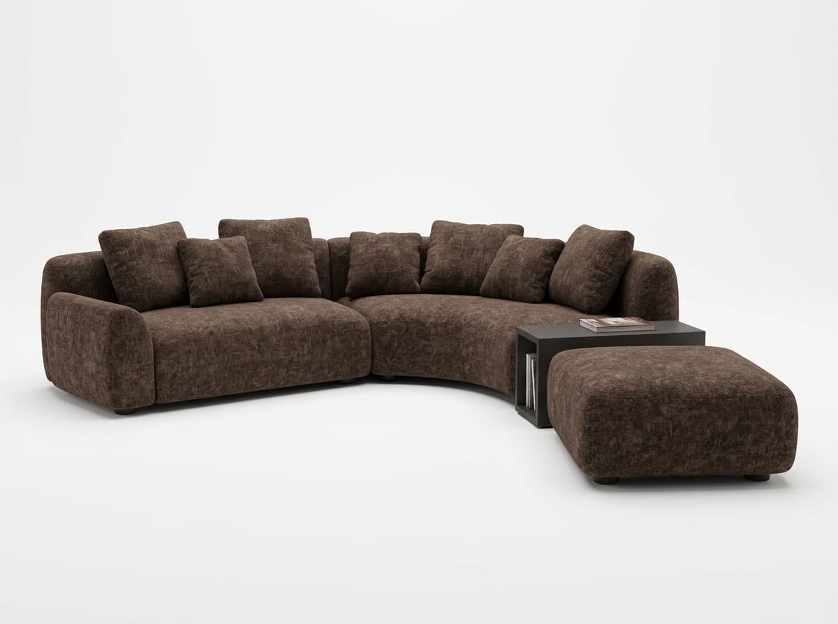 A large, modular sectional sofa with a curved configuration, upholstered in a textured brown fabric. The sofa features deep seating and multiple plush throw pillows. Adjacent to the sofa is a small, dark-colored modular unit that serves as a side table or storage, and a matching upholstered ottoman. — 3D model