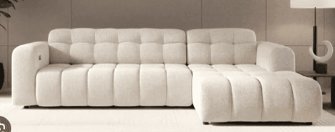 A modern, light-colored sectional sofa featuring distinct channel tufting across its seat and backre… — 3D model