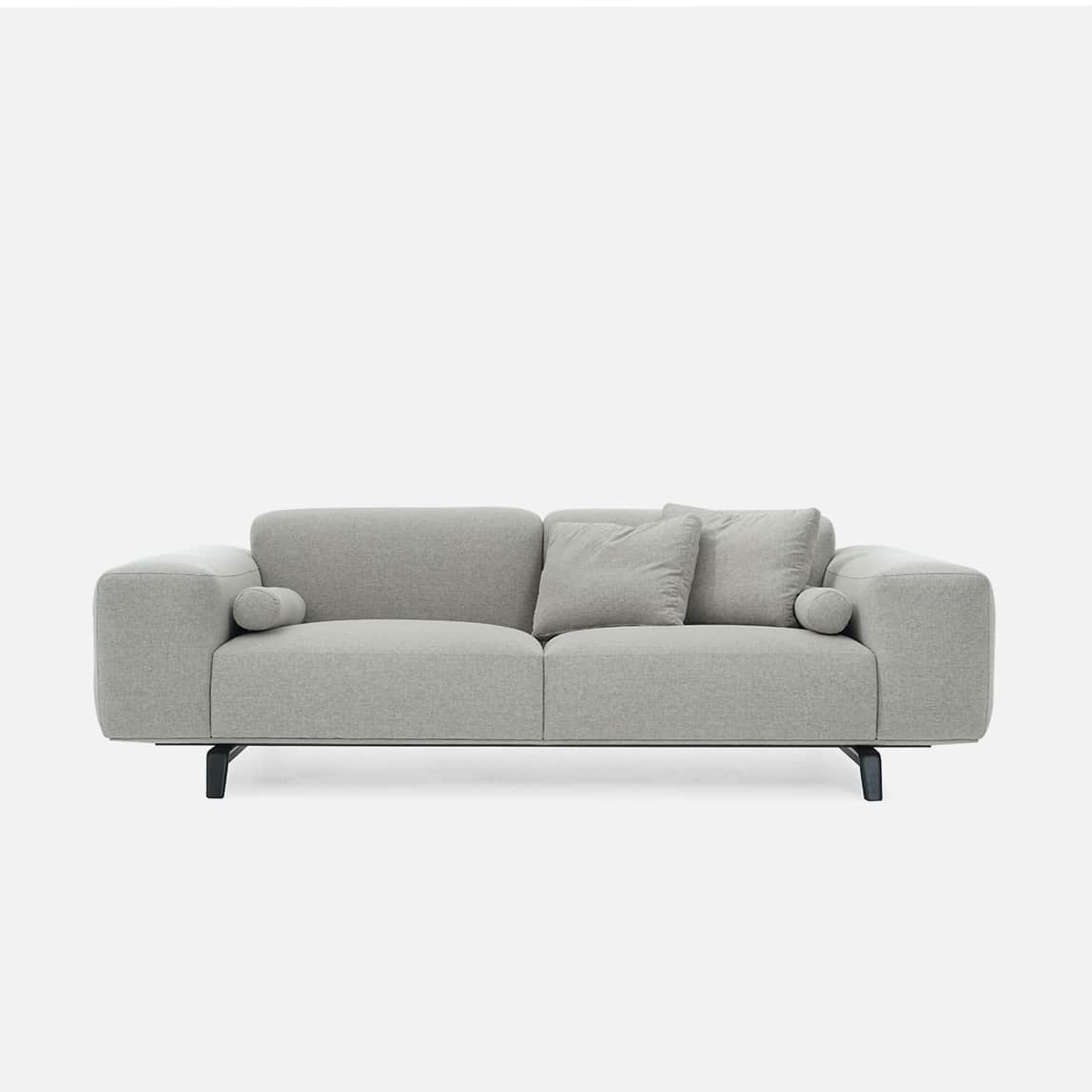 A modern upholstered sofa in a light grey fabric, featuring two main seat and back cushions, with in… — 3D model