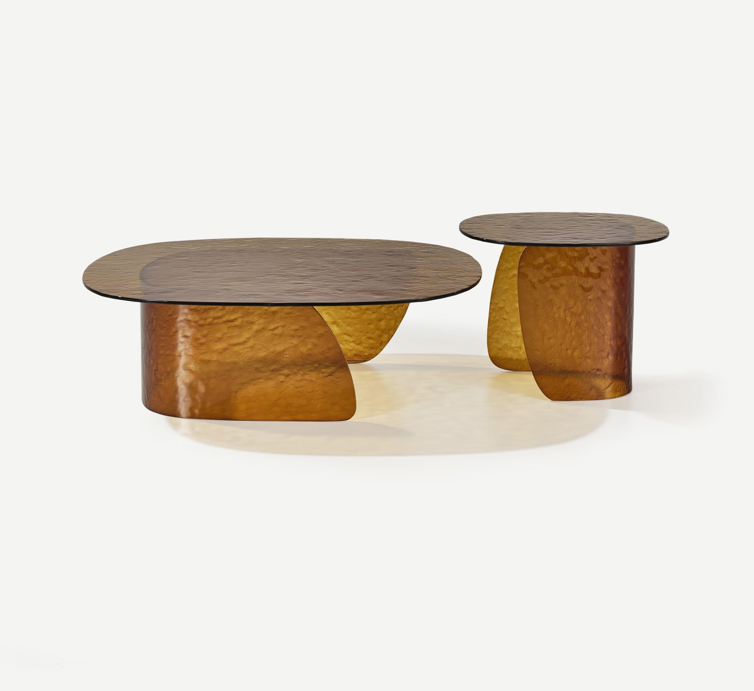 A set of two coffee tables, one oval and one round, with textured amber glass tops and similarly textured, abstract bases. The bases appear to be made of a molded material, possibly resin or composite, with a metallic sheen in shades of amber and gold. The design is modern and sculptural. — 3D model