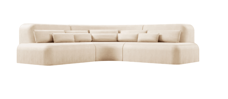 A large, cream-colored sectional sofa with rounded edges and multiple throw pillows. The sofa appears to be upholstered in a soft fabric, possibly velvet or a similar textile. It is configured in an L-shape, suggesting it is designed for a corner placement. The design is modern and minimalist, with clean lines and a low profile. — 3D model
