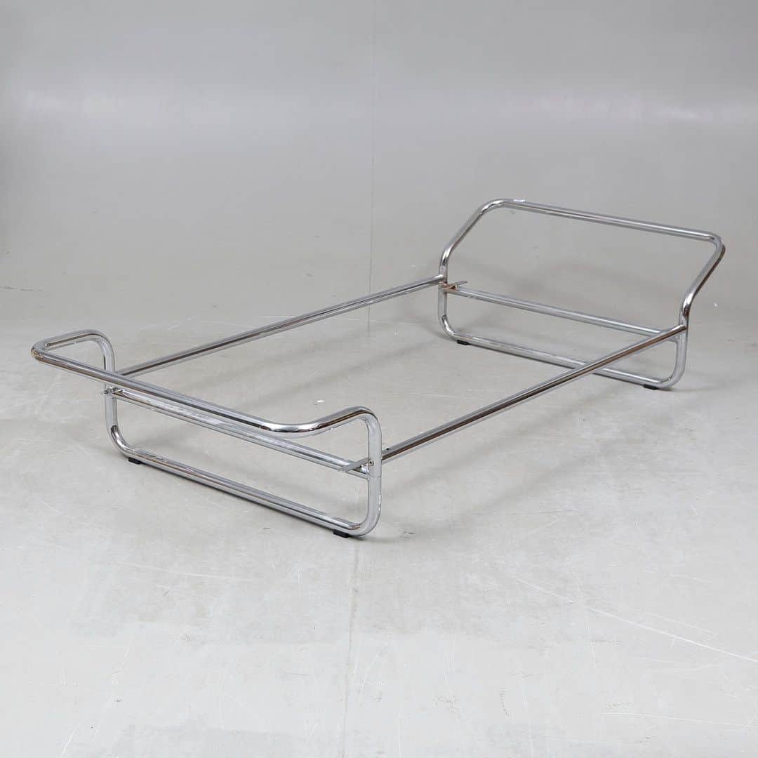 A minimalist bed frame constructed from polished chrome-plated tubular metal. It features a rectangu… — free OBJ 3D model