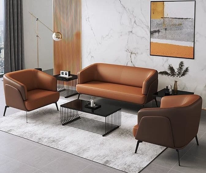 A modern two-seater sofa featuring rich cognac-colored leather upholstery and slender black metal legs. The design is characterized by integrated, gently sloped armrests that flow seamlessly into the backrest, creating a sleek and cohesive profile. The seating area is composed of a single, continuous cushion, contributing to its minimalist aesthetic. The overall appearance is contemporary and sophisticated. — 3D model
