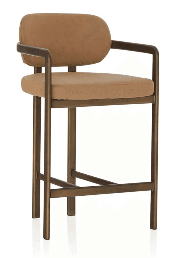 A contemporary bar stool featuring a sturdy metal frame with a bronzed finish, complemented by a padded seat and a gently curved backrest, both upholstered in a light brown fabric. The design includes integrated armrests and a footrest bar for comfort. — 3D model