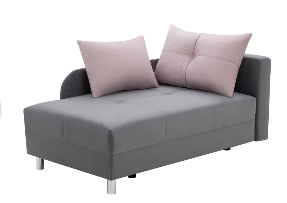 A modern grey fabric chaise lounge featuring a low-profile design. It has a rounded armrest on the left side and a low backrest on the right. The seat cushion displays button tufting, and it is accompanied by two light pink square throw pillows. The lounge is supported by short, cylindrical metal legs. — 3D model
