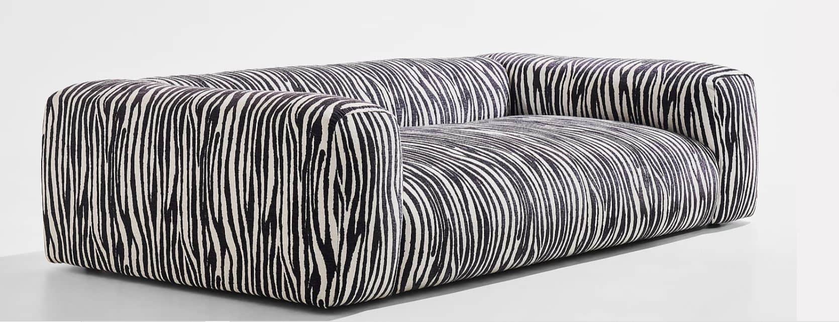 A contemporary two-seater sofa featuring a distinctive black and white zebra stripe pattern upholste… — free GLTF 3D model