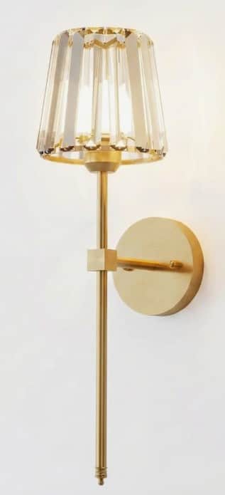 A contemporary wall-mounted light fixture featuring a brushed brass finish and a beige pleated conic… — 3D model