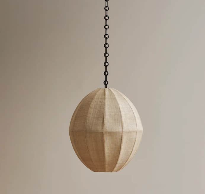 A spherical pendant light featuring a natural-toned, ribbed fabric shade suspended by a black metal… — 3D model