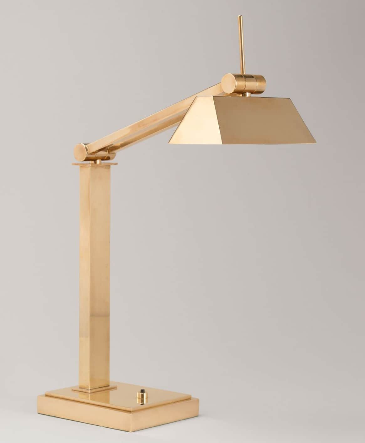 A sleek, modern desk lamp crafted from polished brass, featuring an adjustable arm and a geometric,… — 3D model