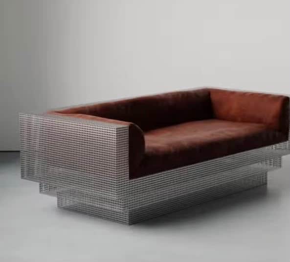 A contemporary two-seater sofa featuring a distinctive perforated metal frame and warm brown leather… — 3D model