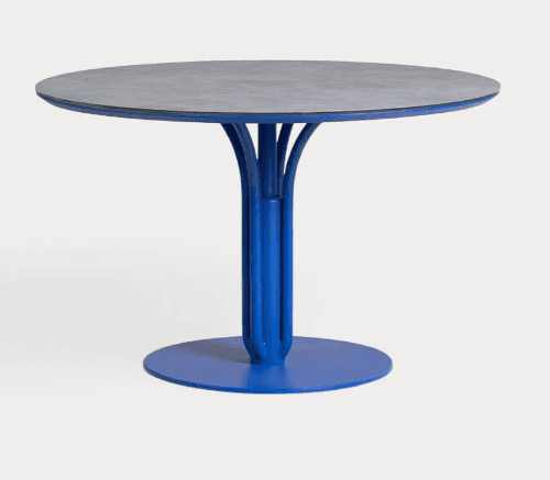 A round dining table with a central pedestal base. The tabletop has a grey, textured surface with a… — free GLB 3D model