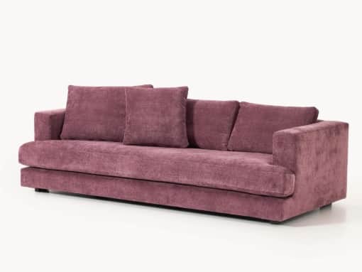 A three-seater sofa with a low profile and plush upholstery. It features wide armrests and a deep se… — 3D model
