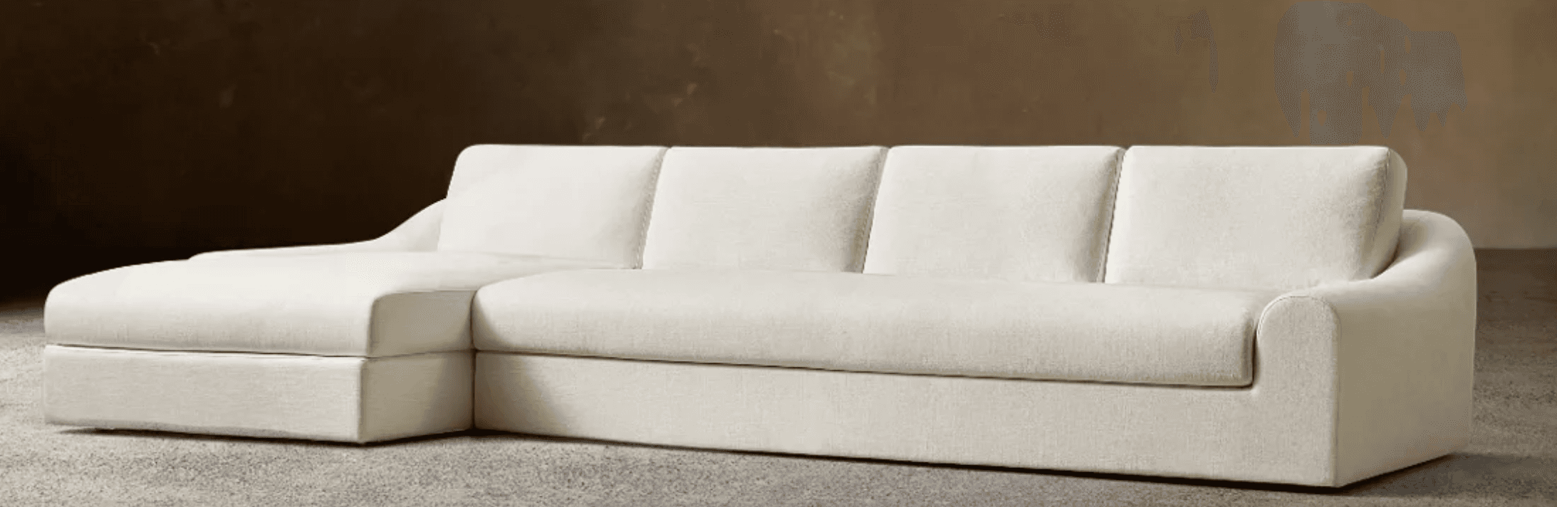 A light-colored contemporary sectional sofa featuring a right-hand chaise lounge component, plush seating, and subtly curved arms. — 3D model